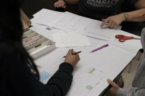 Students work on final calculations for presentation