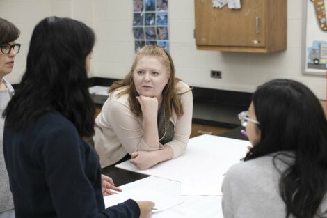 Adviser help ACE students as they prepare final presentations