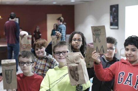 A group of fourth graders pose with their decorated bags