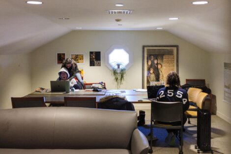 Students in the Ramer History House study space are doing something, but I'm not sure what.