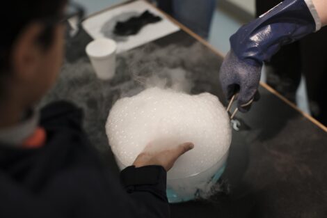 Students touch the soapy dry ice water