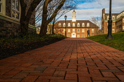 A brick walkway behind the Farinon Center with one student in the distance on the first day of spring semester