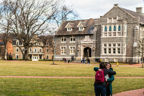Two students hug on the Quad on the first day of spring semester.