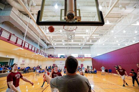 Athletes lead elementary students through a basketball activity