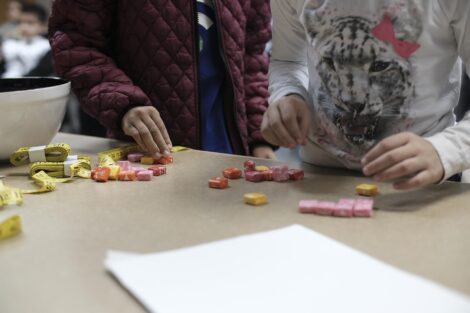 Elementary students count out the candy they grabbed