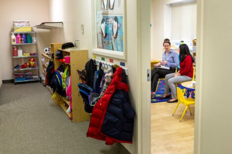 Host sits in classroom with student extern