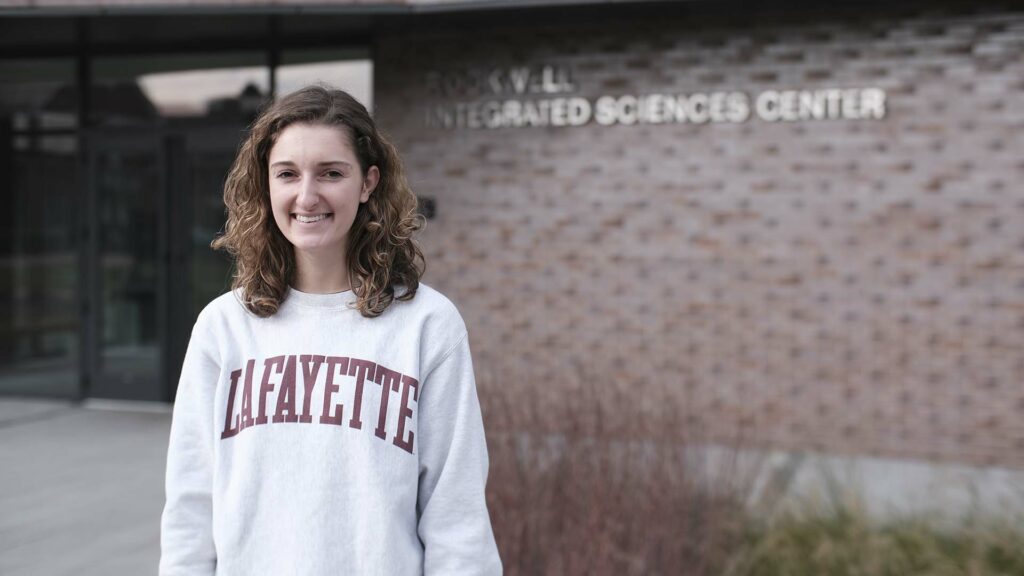 Autumn Paone ’22 stands outside Rockwell Integrated Sciences Center