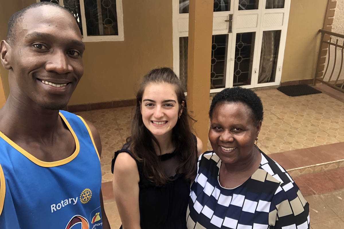 Victoria Puglia ’21 smiles in a selfie with her host family in Uganda