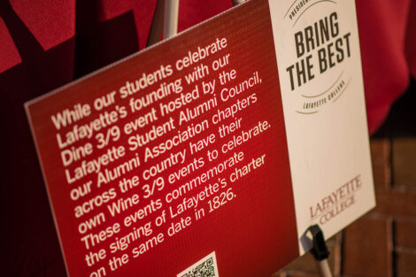 Sign reads: while our students celebrate Lafayette's founding with our Dine 3/9 event hosted by the Lafayette Student Alumni Council, our Alumni Association chapters across the country have their own Wine 3/9 events to celebrate. These events commemorate the signing of Lafayette's charter on the same day in 1826.