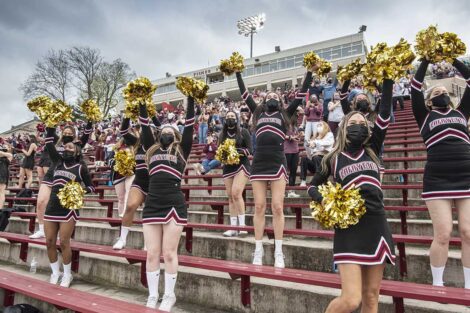 Lafayette College cheerleaders cheer on football players at Fisher Field
