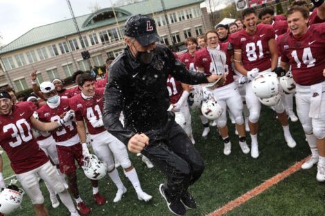 Lafayette College football coach celebrates with the team after winning the 156 Rivalry against Lehigh