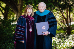 Alison Byerly poses with Dick McAteer, who holds his honorary degree.