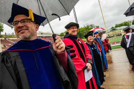faculty smile as seniors walk toward Fisher Field Commencement 2021 2