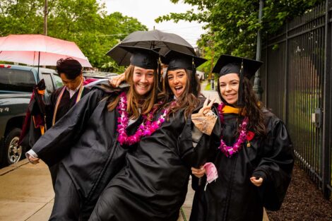 seniors in caps and gowns smiling pre Commencement 2021