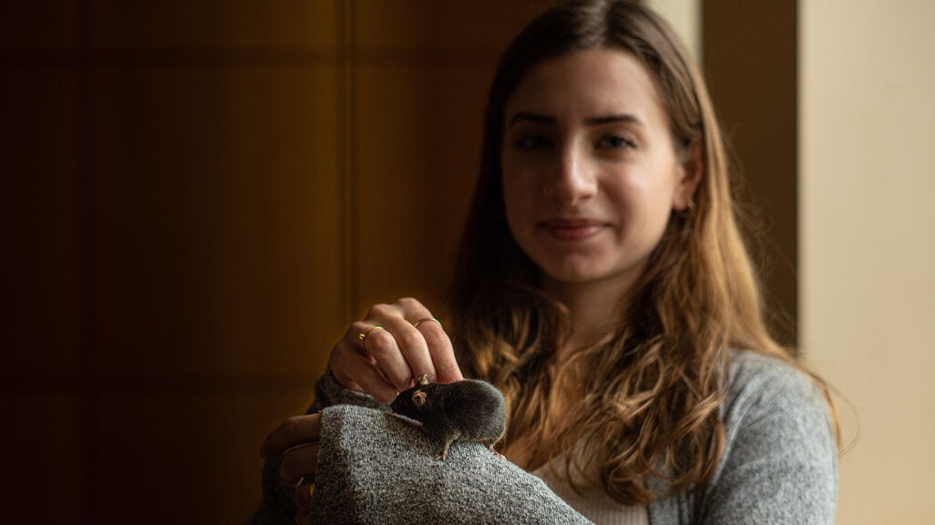 Nicole Toumanios with a lab mouse