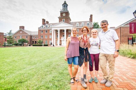 Lafayette student with family stand in front of Watson Hall