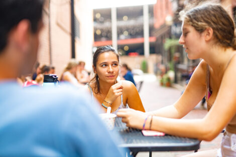 A group of students talk at a table in downtown Easton.