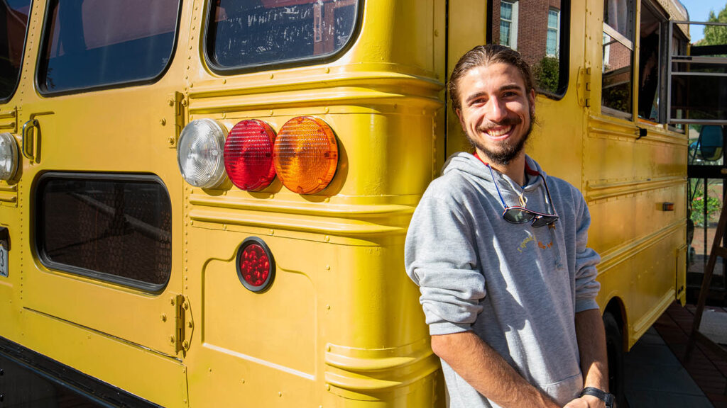 Remy Oktay '23 outside of converted bus.
