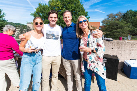 Families smile on Markle Parking Deck while tailgating.