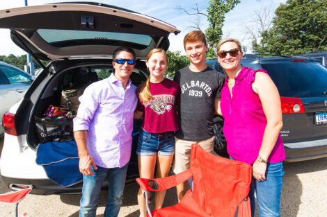Families smile on Markle Parking Deck while tailgating.