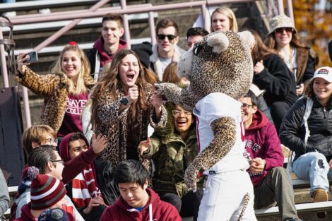 Leopard mascot in the stands with cheering students