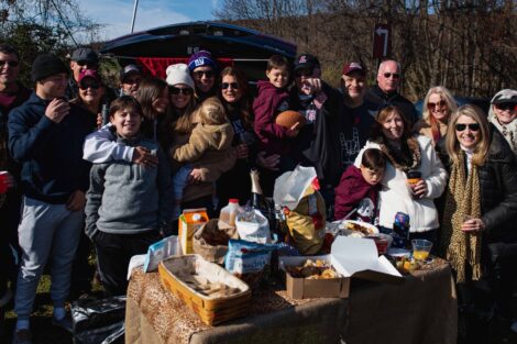 large group of alumni tailgate with children and family members in Leopard gear