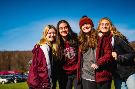 group of four students in Lafayette gear smile outside Goodman Stadium