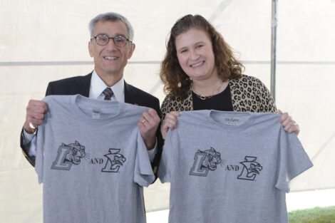 Lehigh President Joseph J. Helble and Nicole Hurd hold gray Rivalry T-shirts