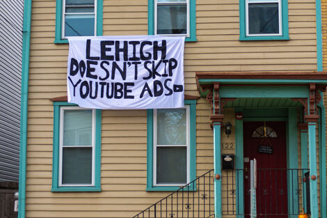 A banner hanging in College Hill reads: Leigh doesn't stop Youtube ads.