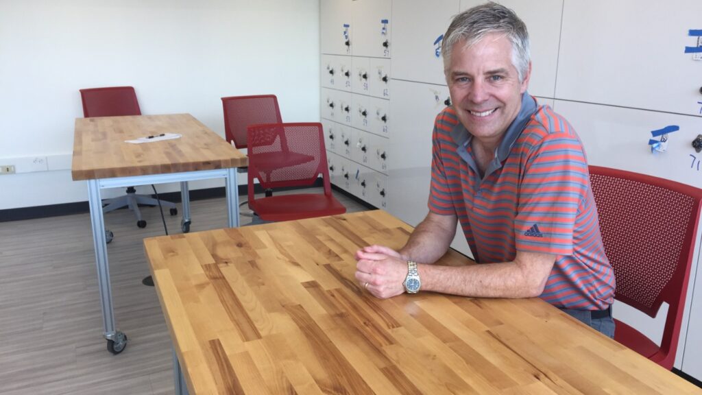 Scott Hummel, director of engineering, at one of the tables he helped design