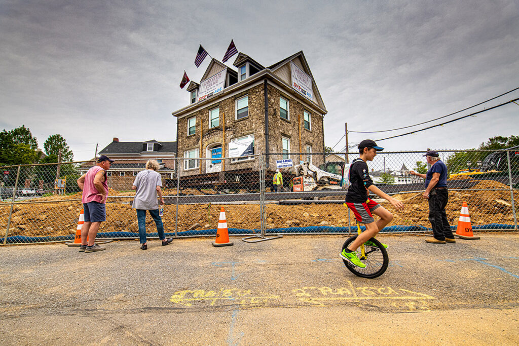 A person riding a unicycle in front of the construction site of Portlock