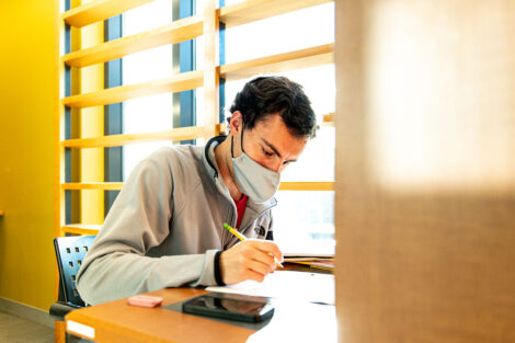 student studies at a desk in Skillman library