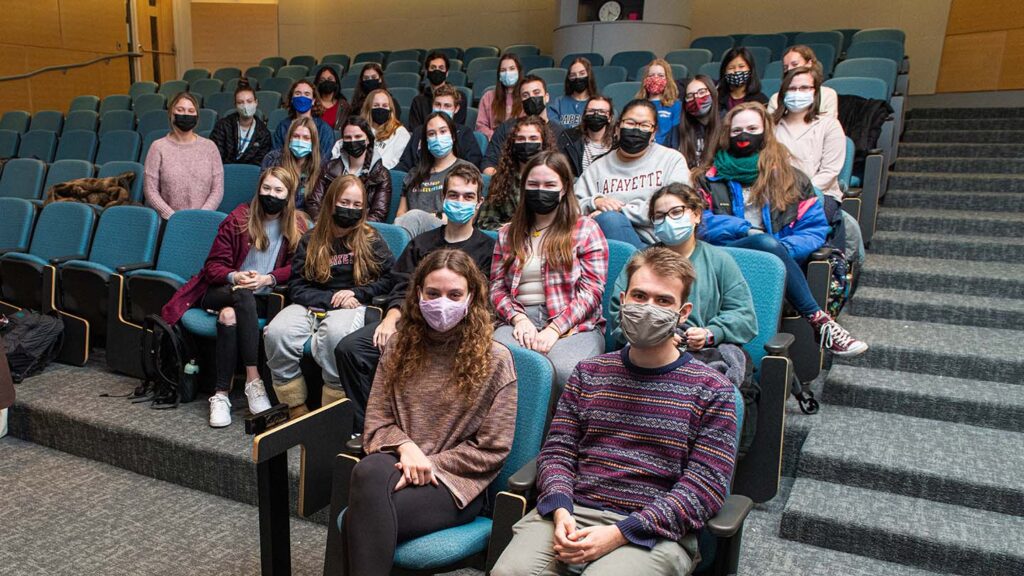 Masked APO members sit inside Hugel lecture hall