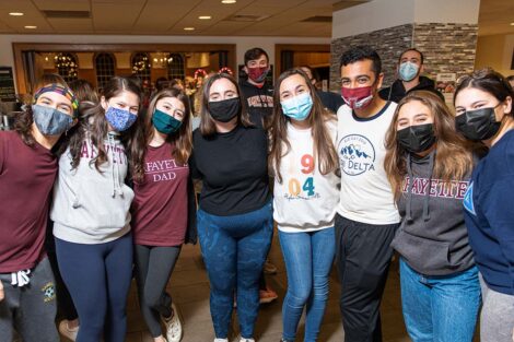 group of students in Marquis stand together in masks