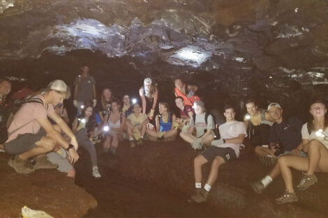 Winter Interim Study Abroad students inside the Kaumana Caves Lava Tube.