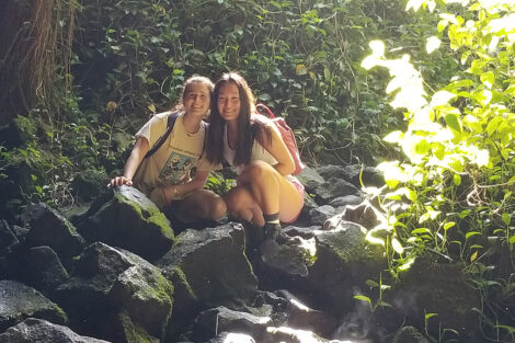 Sherry Deng '22, and Kate Rogers '22 in the sunlight before entering Kaumana Caves.