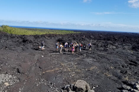 Students walk around the Lower East Rift Zone Eruption site in Hawaii