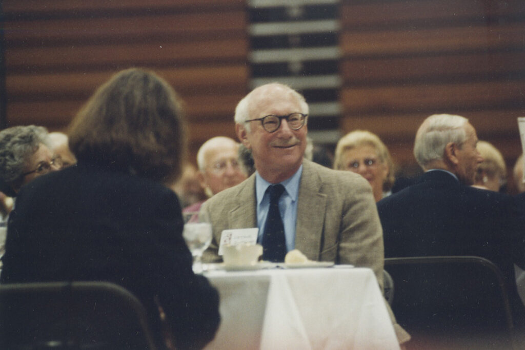 Arthur Rothkopf ’55 H’05 smiles while sitting in a crowd.