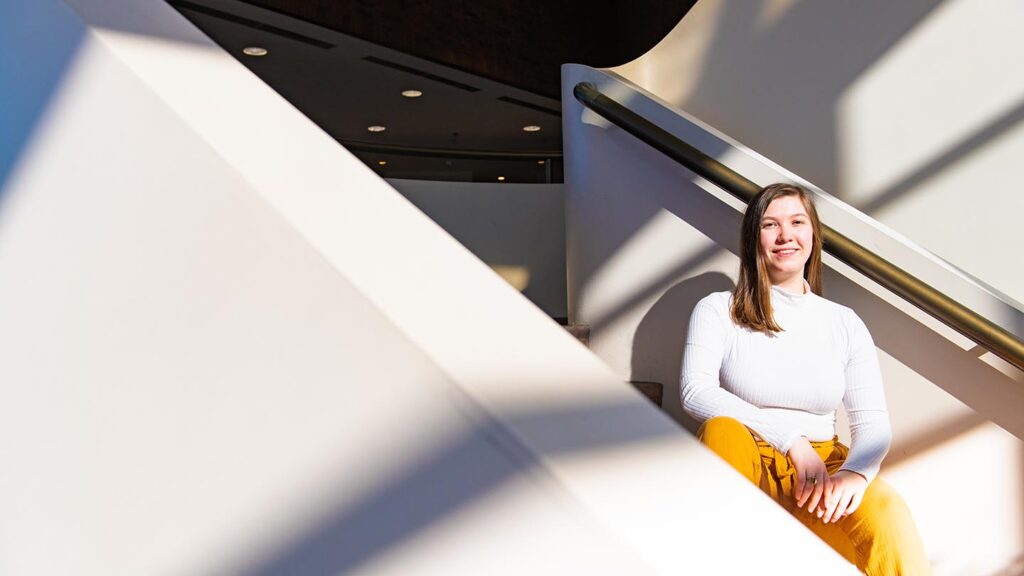 Student sits on steps in Williams Center for the Arts