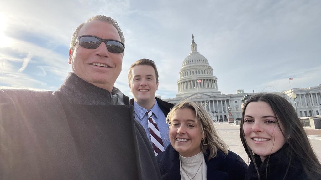 Host and three externs take selfie in front of the US Capital