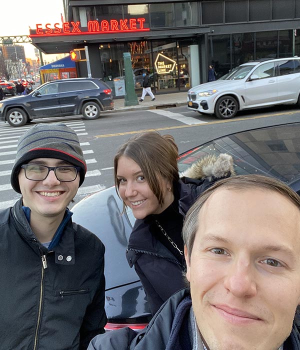 Selfie of three people in front of the Essex Market