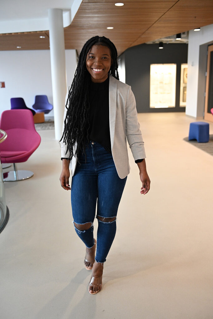 Shantae Shand smiles as she walks through Rockwell Integrated Sciences Center.