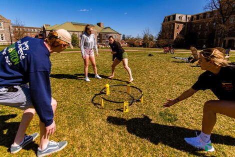 students playing ball on the Quad, warm sunshine