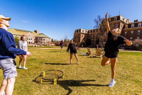 students playing ball on the Quad, warm sunshine