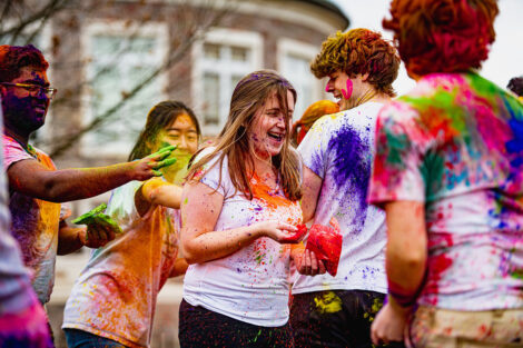 Students covered in colorful powder.