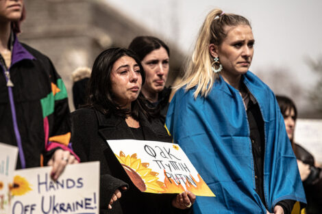 students hold signs in support of Ukraine on Quad