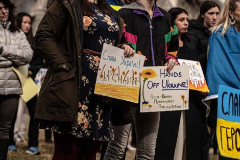 students hold signs in support of Ukraine on Quad