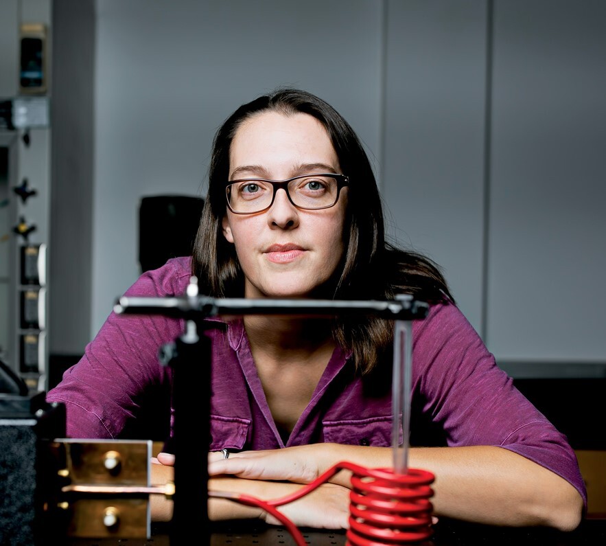 Zoe Boekelheide, associate professor of physics at Lafayette, sits behind a desk in a science laboratory