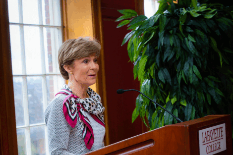 Betsy Fadem '76 stands at podium and presents at the 15th scholarship reception. Fadem created a scholarship to honor women athletes.