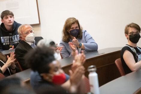 John Hatfield and Nicole Farmer Hurd clap in Kirby Hall of Civil Rights lecture room